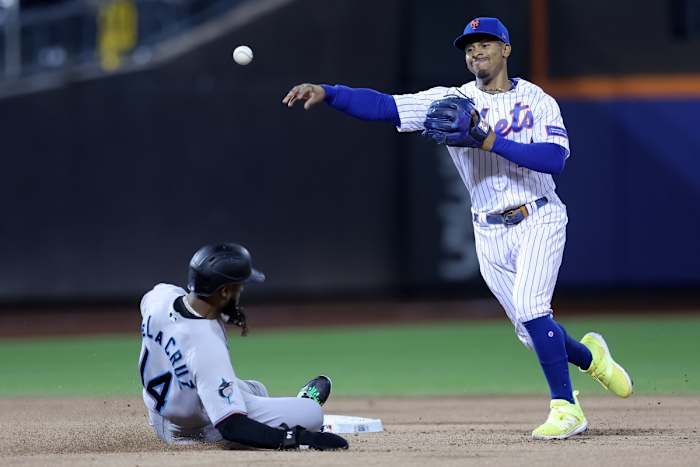 Sep 28, 2023; New York City, New York, USA; New York Mets shortstop Francisco Lindor (12) steps on second to force out Miami Marlins right fielder Bryan De La Cruz (14) and throws to first to attempt a double play on a ball hit by Marlins shortstop Garrett Hampson (not pictured) during the second inning at Citi Field. Hampson was safe at first on the play.